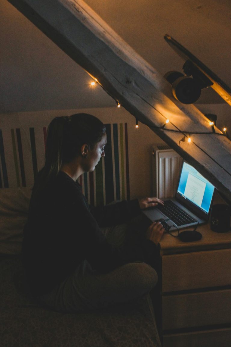 Woman in Black Long Sleeve Shirt Using Laptop Computer